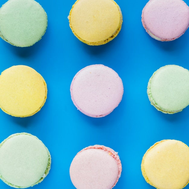 Fresh macaroons on blue background