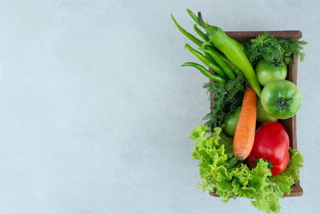 Fresh mixed vegetables in wooden box.