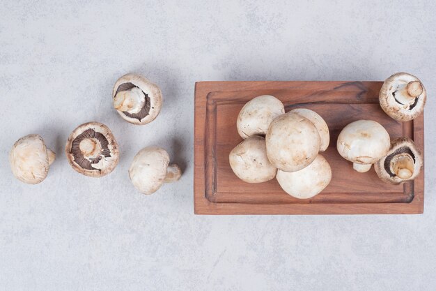 Fresh mushrooms on wooden plate. 