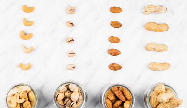 Free photo fresh nut food in jar on marble surface