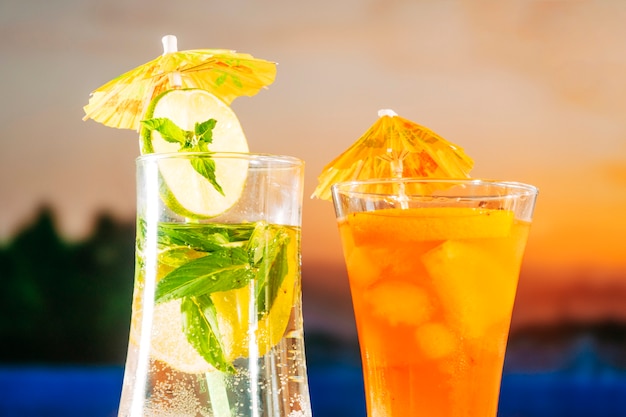 Fresh orange drinks with sliced lime mint ice cubes