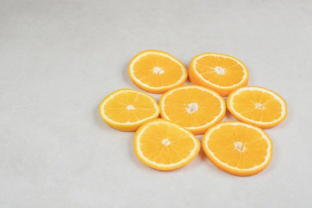 Fresh orange slices on gray surface.