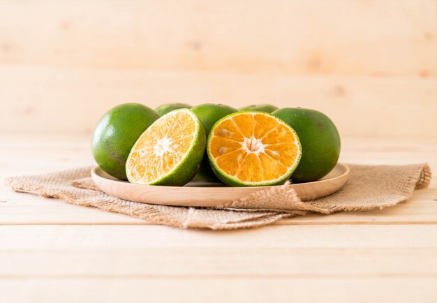 fresh orange on wood plate