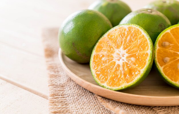 fresh orange on wood plate