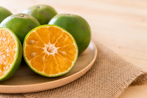 fresh orange on wood plate