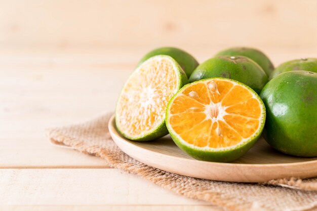 fresh orange on wood plate