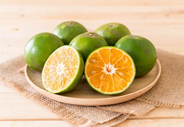 fresh orange on wood plate