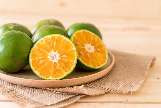 fresh orange on wood plate