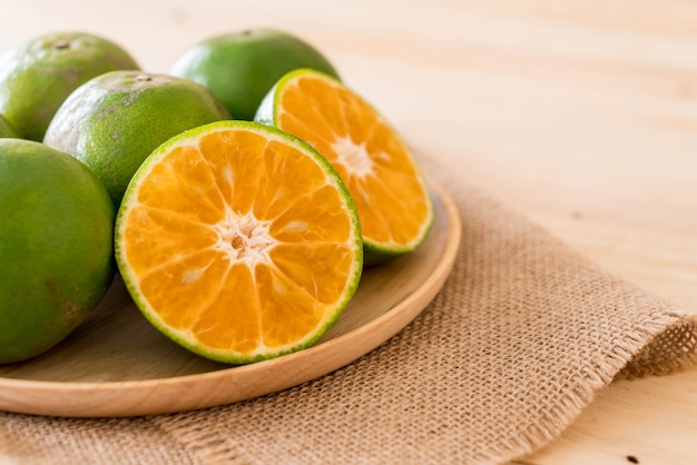 fresh orange on wood plate