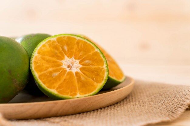 fresh orange on wood plate