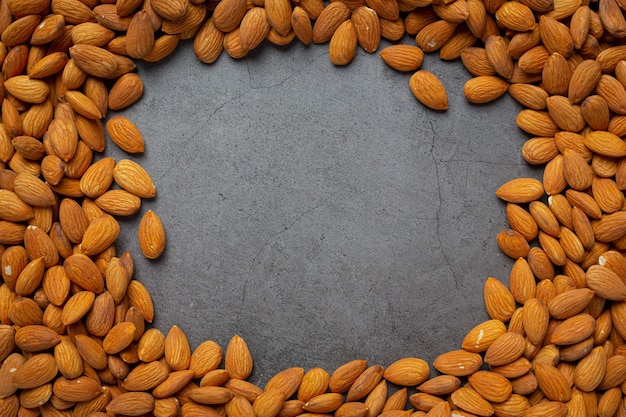 Fresh organic almonds  on dark background