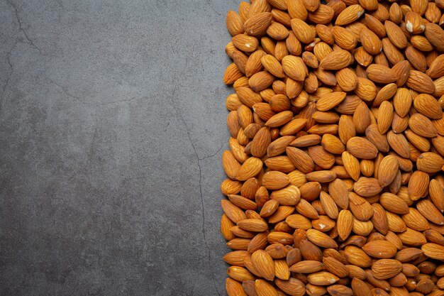 Fresh organic almonds  on dark background