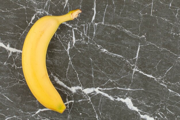 Fresh organic banana on black stone