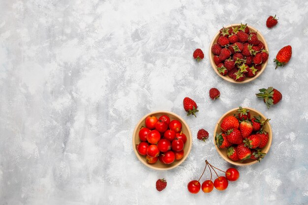 Fresh organic berries on grey concrete , top view,copyspace