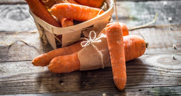 Fresh organic carrots, a bunch of carrots lying on wooden boards