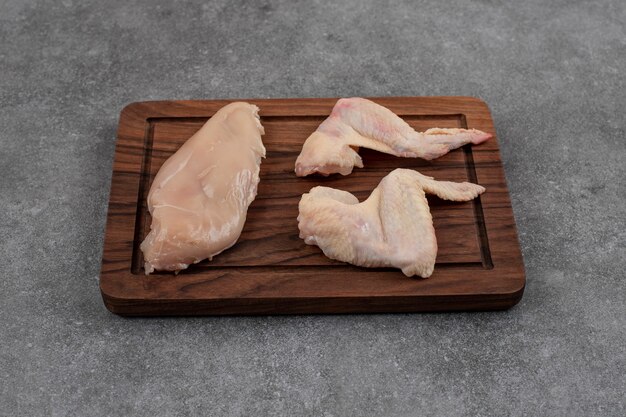 Fresh organic chicken meats. Raw meats on wooden board. 