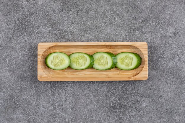 Fresh organic healthy cucumber slices on wooden board