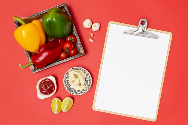 Fresh organic ingredients next to clipboard