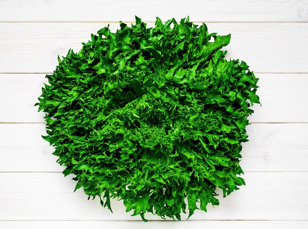 Fresh organic lettuce on a white wooden table