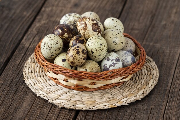 Fresh organic quail eggs on the old wooden table