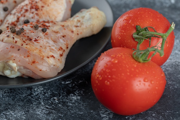 Fresh organic tomatoes with chicken drumsticks.