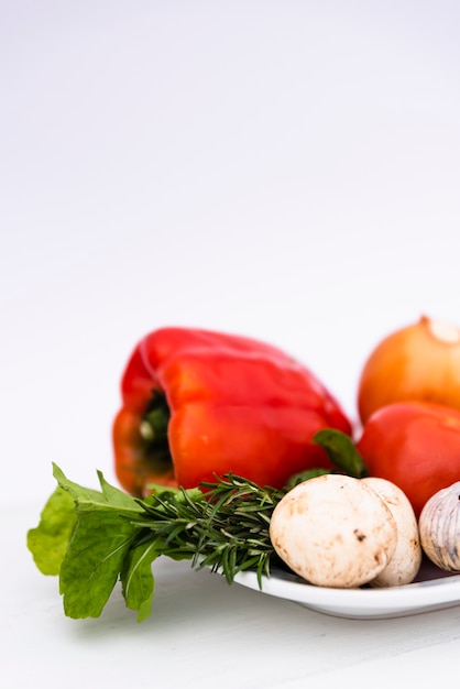 Fresh organic vegetable in white tray on white background