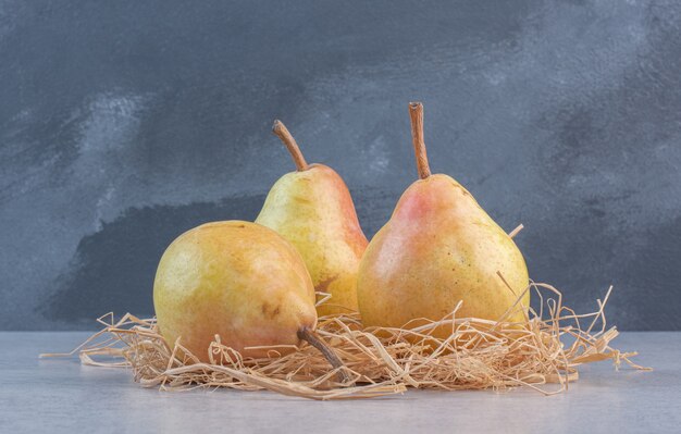 Fresh organic yellow pears on grey background. 