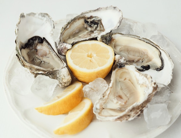 Free photo fresh oyster with lemon on a plate