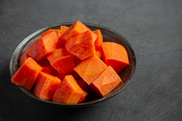 Fresh papaya, cut into pieces, put on a silver plate.