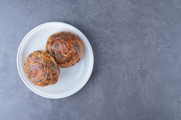 Fresh pastries Gogal on a plate on marble table.