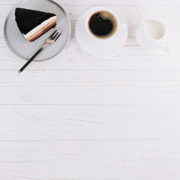 Fresh pastry and cup of tea for breakfast on wooden table