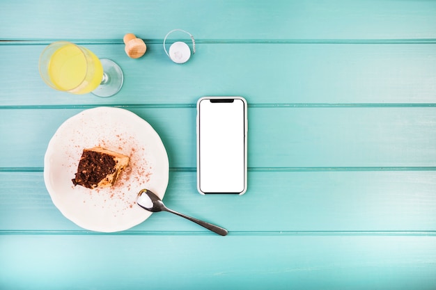 Fresh pastry with drink and cellphone on table