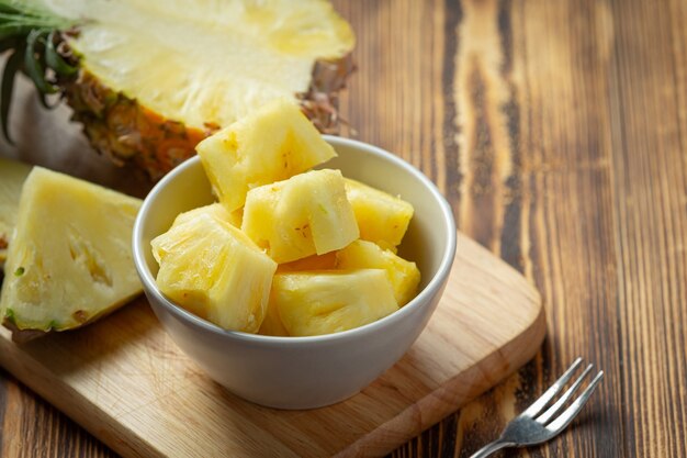 Fresh pineapple on dark wooden surface