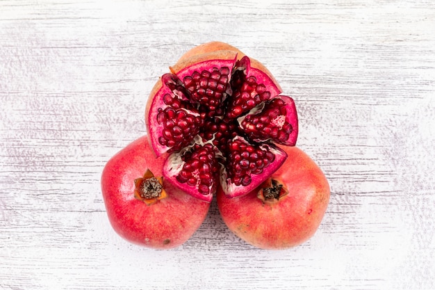 Free photo fresh pomegranate top view on white wooden surface