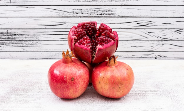 Fresh pomegranate top view on white wooden surface