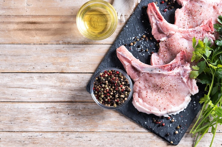 Free Photo fresh pork chops on wooden table