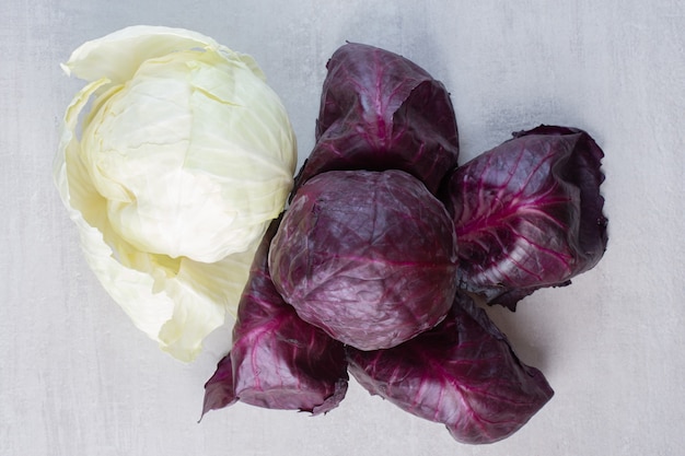 Fresh purple and white cabbages on stone surface. High quality photo