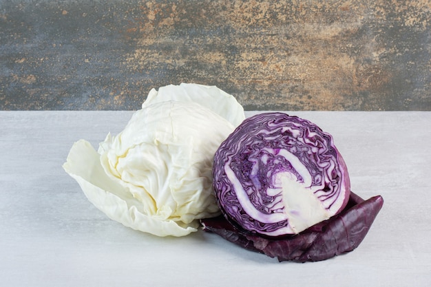 Fresh purple and white cabbages on stone table. High quality photo