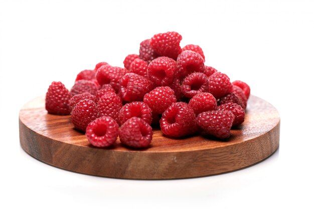 Fresh raspberries on wooden surface