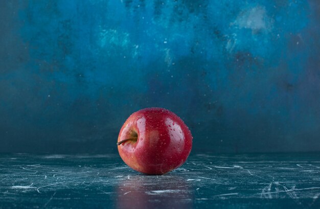 Fresh red apple on marble table. 