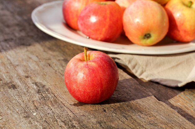 Fresh red apples on a wooden table