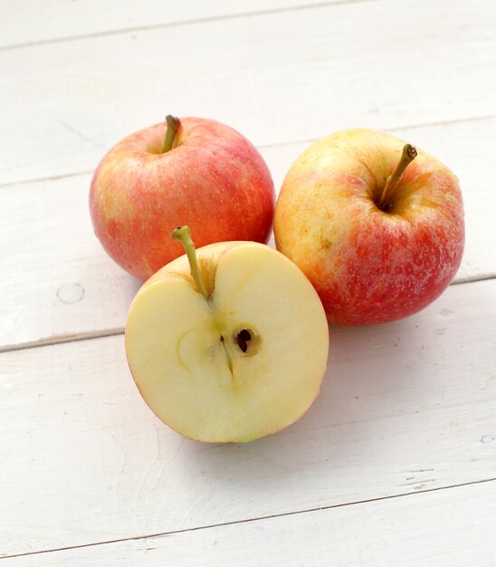 Fresh red apples on a wooden table