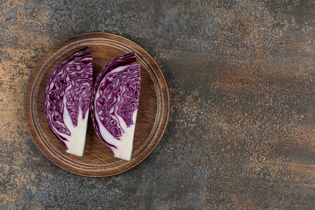 Fresh red cabbage chopped on a board  on the marble surface