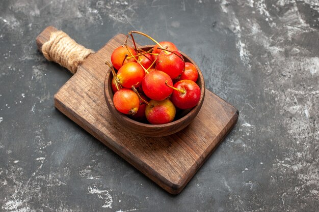 Fresh red cherry fruit in a bowl on gray background