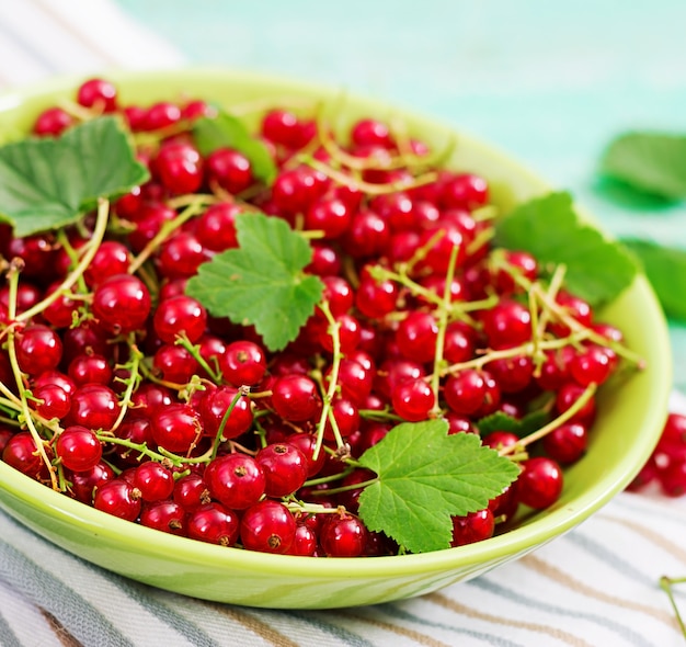 Free photo fresh red currant in a bowl on a wooden table