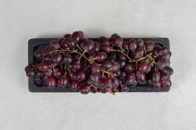 Fresh red grapes on black plate