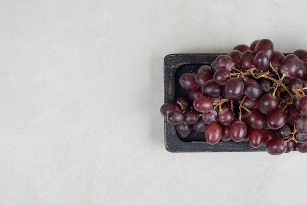 Fresh red grapes on black plate