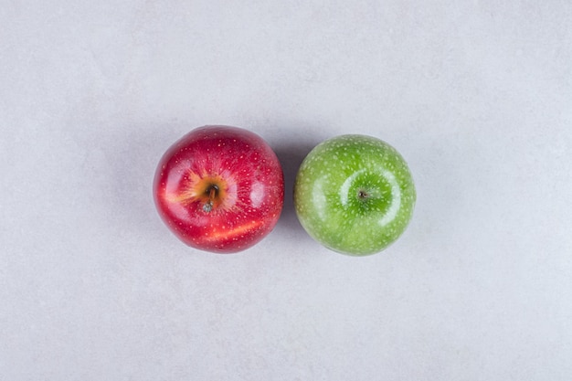 Fresh red and green apples on white background.