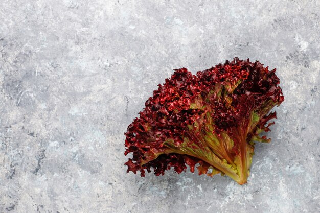 Fresh red lettuce on grey concrete table, top view
