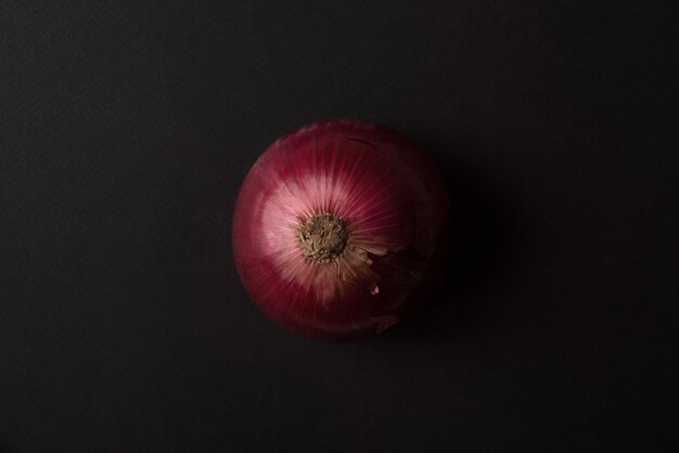 Fresh red onion over black